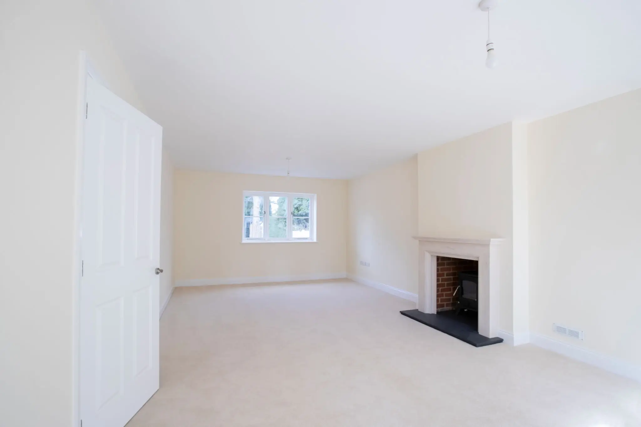 Empty room with fireplace and window